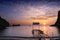 Sunset on the water edge with a deserted boat launch in the foreground