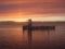 Sunset at water with old pier