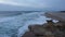 After sunset, the waves on the beach in Nazare.