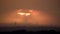 Sunset with wind turbines in a distant landscape