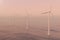 Sunset wind turbines in sea, ocean. Clean energy, wind energy, ecological concept. 3d rendering