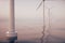 Sunset wind turbines in sea, ocean. Clean energy, wind energy, ecological concept. 3d rendering