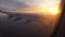 Sunset in the window of the plane. beautiful view of the aircraft wing. passenger transportation and travel