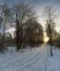 Sunset in a winter forest with a distant road.