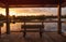 Sunset Wooden bench on a secluded, tranquil boardwalk along a ma