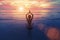 Sunset yoga woman on sea coast.Meditate.