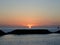 Sunsets behind the ocean with boats on the water