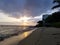 Sunsets over Waikiki waters as waves roll into shore at Makalei