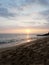 Sunsets over Waikiki waters as waves roll into shore at Makalei