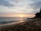 Sunsets over Waikiki waters as waves roll into shore at Makalei