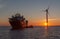 Sunsett with service operational and crew transfer vessels in forground