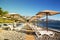 Sunshades and chaise lounges on beach. Summer seascape.