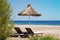 Sunshades and chaise lounges on beach. Summer seascape.