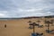 Sunshades and deckchairs on an empty beach