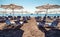 Sunshades with loungers on sandy beach at resort Faliraki in Rhodes island at Greece