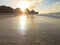 Sunshine on the beach reflections on wet sand