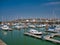 In sunshine on a calm sunny day, leisure boats moored on piers at Maryport Marina in north west Cumbria, England, UK