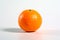 Sunshine in Every Slice: A Fresh Orange on a Clean White Background