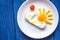 Sunshine fried eggs breakfast for kid on blue background