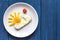 Sunshine fried eggs breakfast for kid on blue background