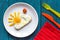 Sunshine fried eggs breakfast for kid on blue background