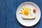 Sunshine fried eggs breakfast for kid on blue background