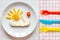Sunshine fried eggs breakfast for kid on wooden background
