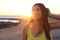 Sunshine lady at sunset. Beautiful smiling woman enjoy life walking on empty beach on sunset