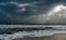 Sunshine pouring over the sea  through the clouds view from beach of somnath