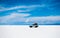 Sunshine scenery of Salar de Uyuni in Bolivia and car