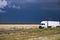 Sunshine semi truck on California road and dark clear sky