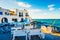 Sunshine view of white restaurant at turquoise stony bay of greek island Paros