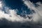 Sunshines through swirling clouds surrounding the mountain tops in Switzerland