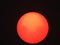 Sunspot clusters visible on orange sun during Canada forest fires