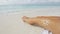 Suntan beach woman tanning legs in water with sun drawing in sunscreen lotion