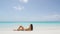 Suntan woman relaxing on summer beach vacation sunbathing