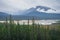 Sunwapta river bed on a very cloudy day in Canadian Rockies. Cold harsh weather in Jasper National Park, Alberta, Canada. Trees,