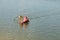 SUP-board swimmer on water near buoy.