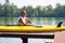 SUP surfer sits next to sup board, relaxes and enjoys life