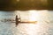 Sup surfer sits on the sup board in the golden light