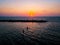 SUP surfers paddling with sunset