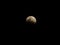 Super blue blood moon with partial lunar eclipse over dark sky background