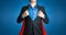 Super business man wears black suits and red robes with super heroes coaching concept on shine blue background and smart.