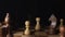 Super close details of chess pieces that stand on a chessboard