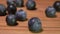 Super close-up of large delicious blueberry falling onto the wooden surface