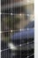 Super closeup view of monocrystalline black solar panel with a white car reflection on it Renewable solar energy concept