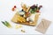 Super and colorful burrito with wheat tortilla, green sauce, avocado and fried chicken, purple color and carrot, corn nachos,