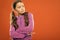 Super confident. Kid girl long curly hair posing confidently orange background copy space. Girl curly hairstyle feels