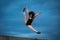Super flexible woman jumping on the sky background. Concept of healthy lifestyle, happiness and joy