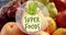 Super foods text banner against close up of fruit basket